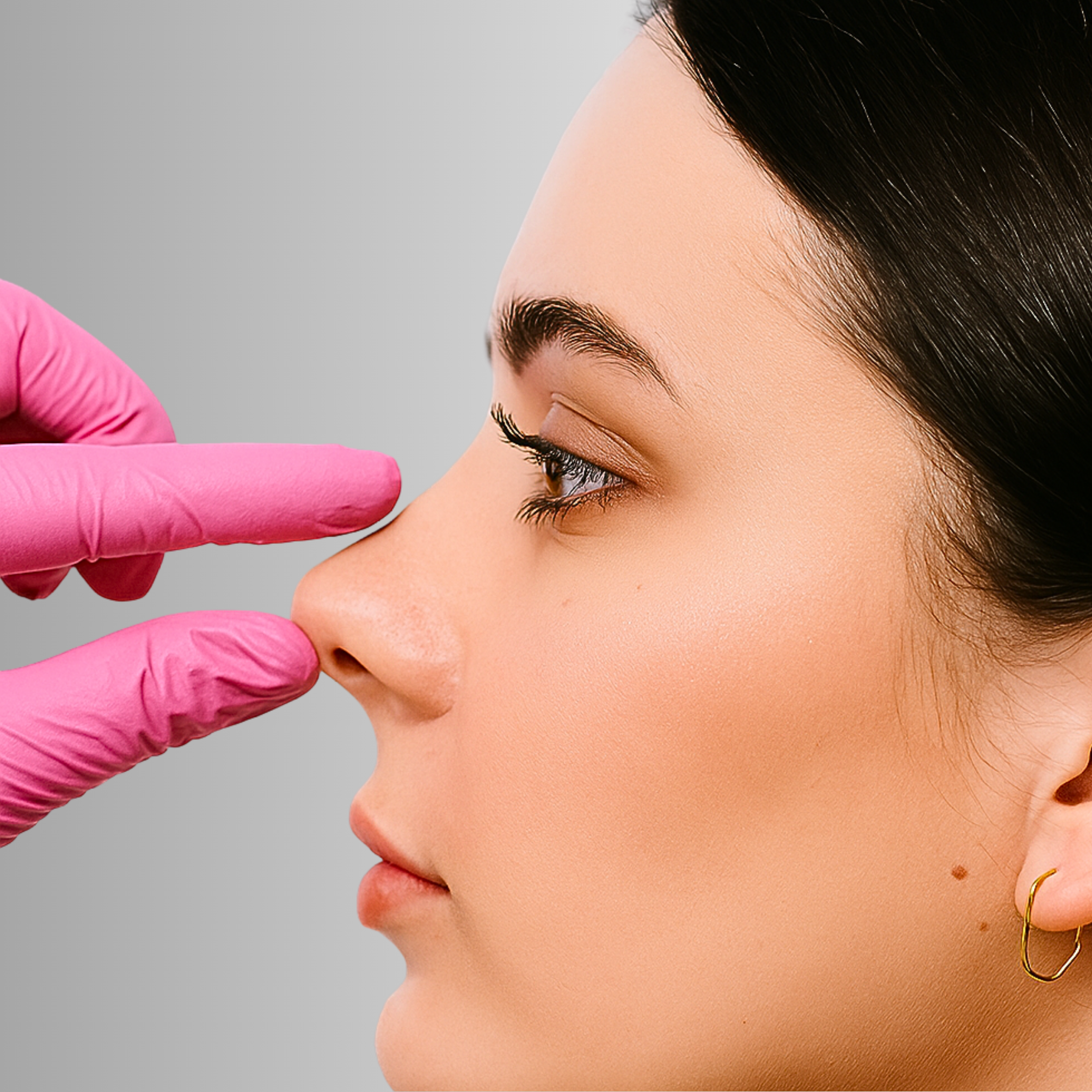 Close-up of a person's face as a healthcare professional in pink gloves examines their nose.