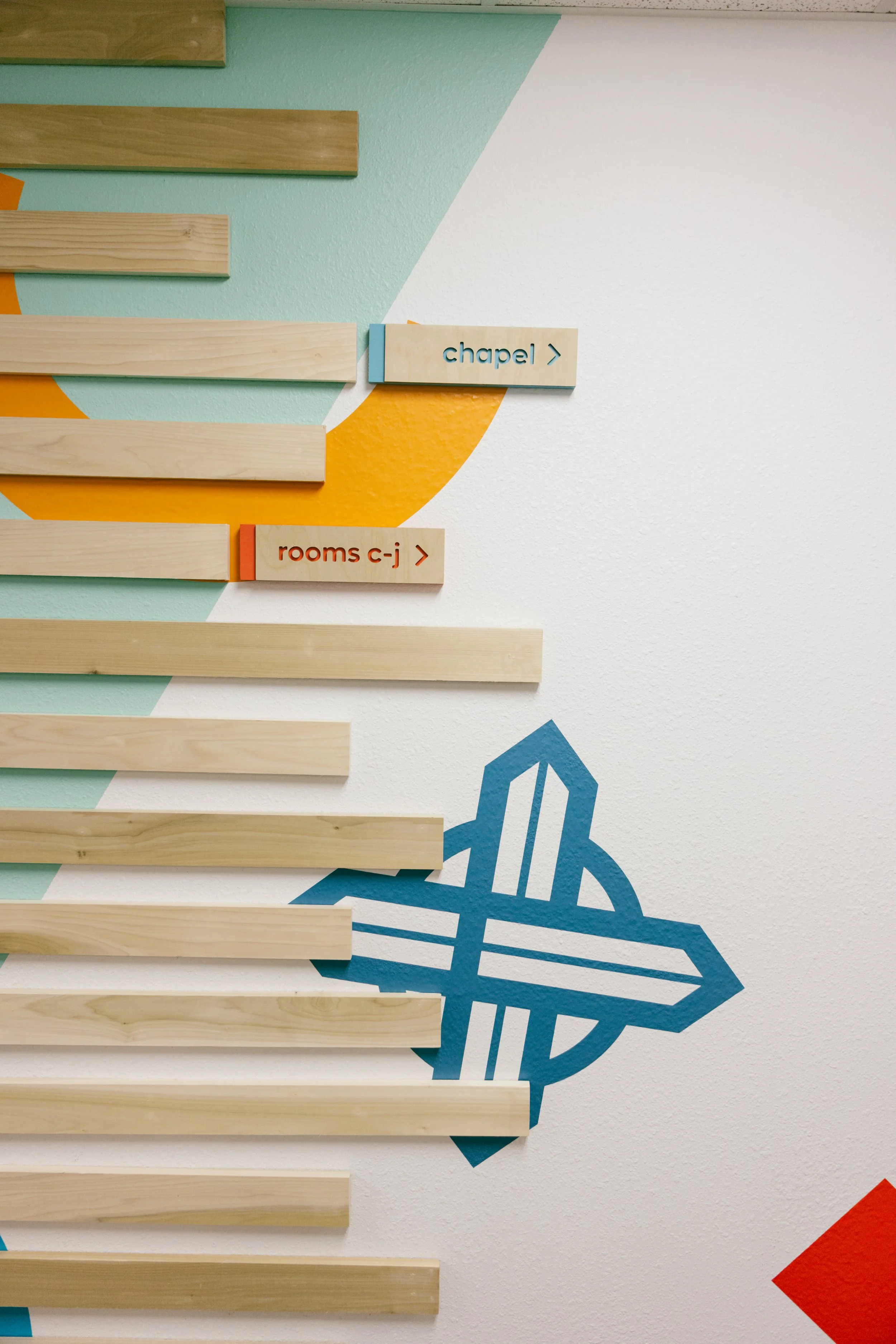 Kids space full environmental makeover. Wood accents, custom directional signs, printed graphics