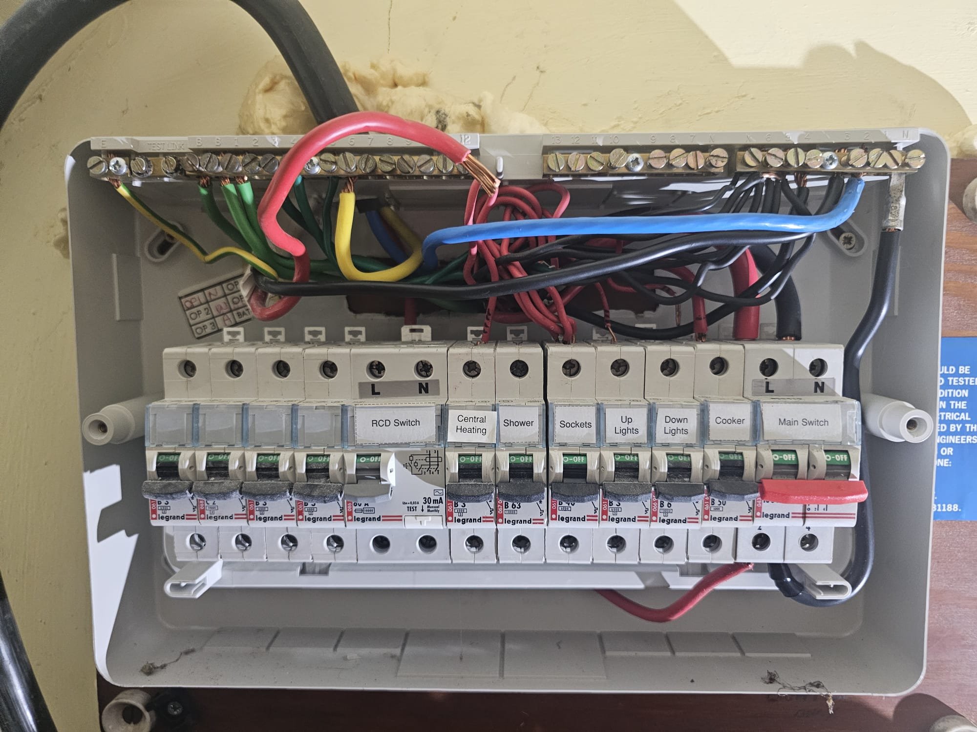 Newly rewired consumer unit with individually labelled circuits including RCD, cooker, shower and sockets, Horley, Surrey