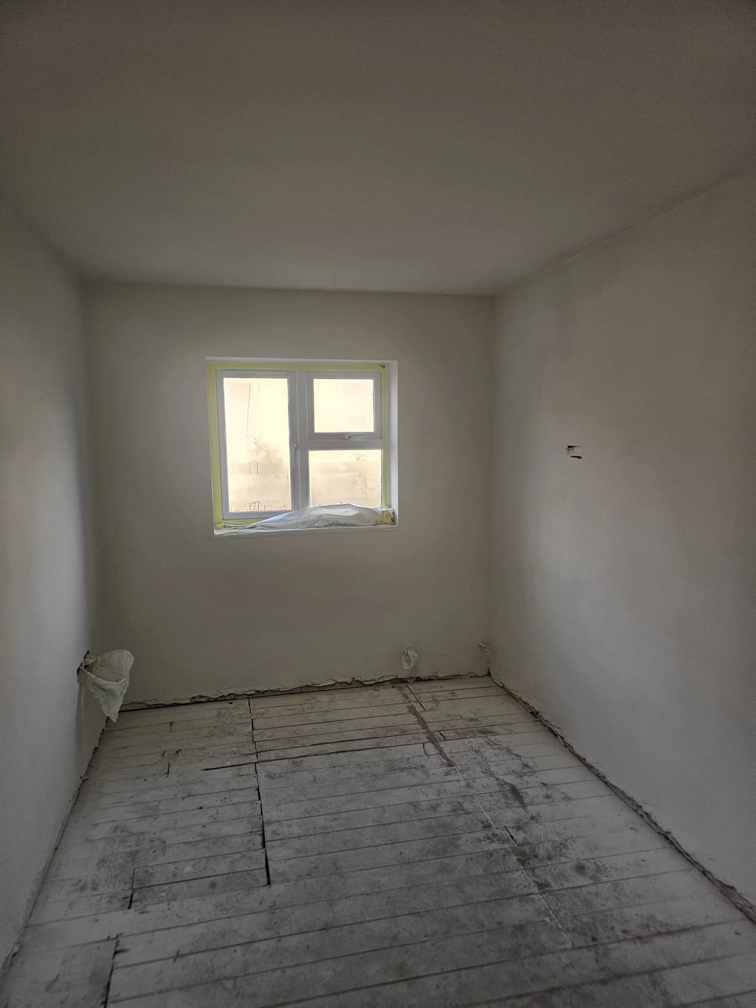 Bare room with window ready for redecoration after rewire, Horley