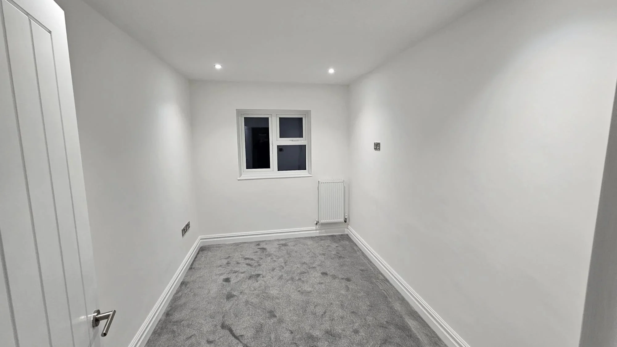 Bedroom in Horley after a full rewire, with LED downlights and new brushed steel sockets
