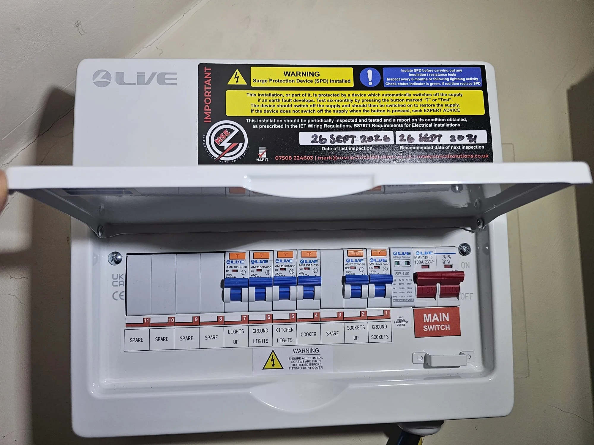 Consumer unit upgrade in Reigate, cover open showing new circuit breakers and main switch