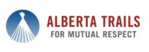 Logo with a red text that says 'Alberta Trails' and a graphic of a lighthouse against a blue circular background.