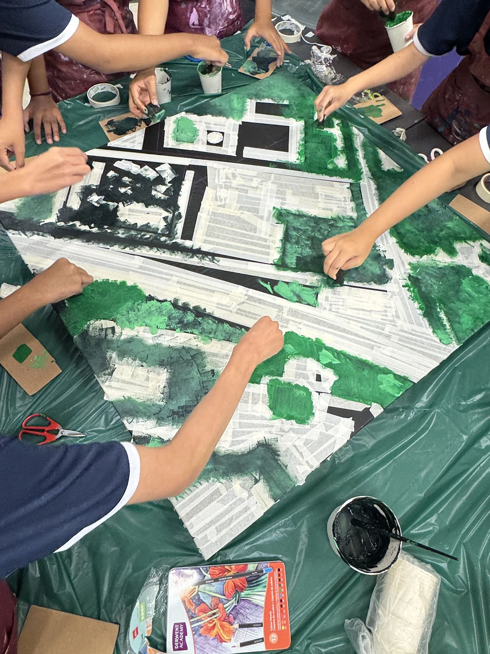 Singapore students at work collaboratively creating a textured painting