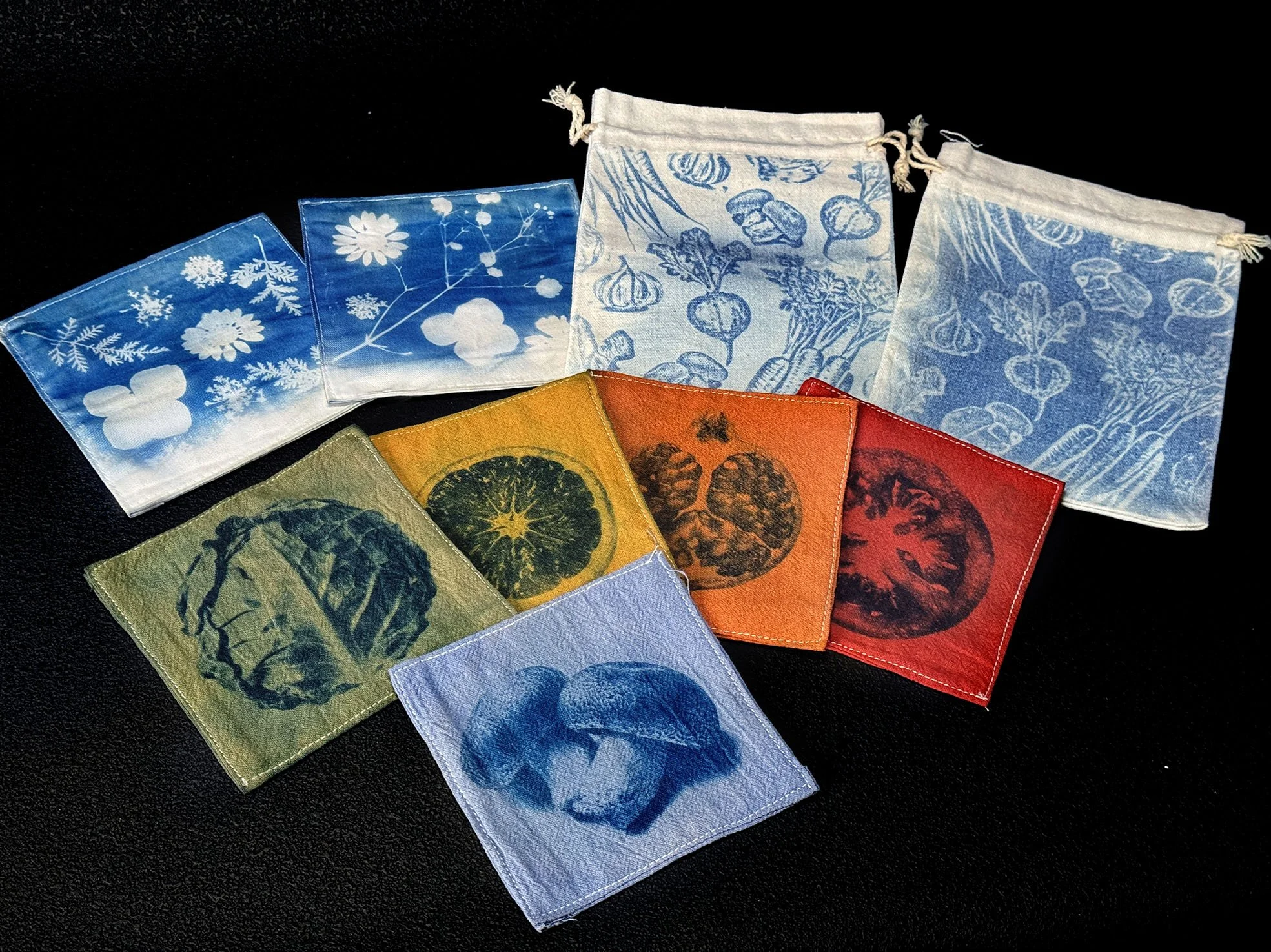Samples of cyanotype coasters and drawstring bags products