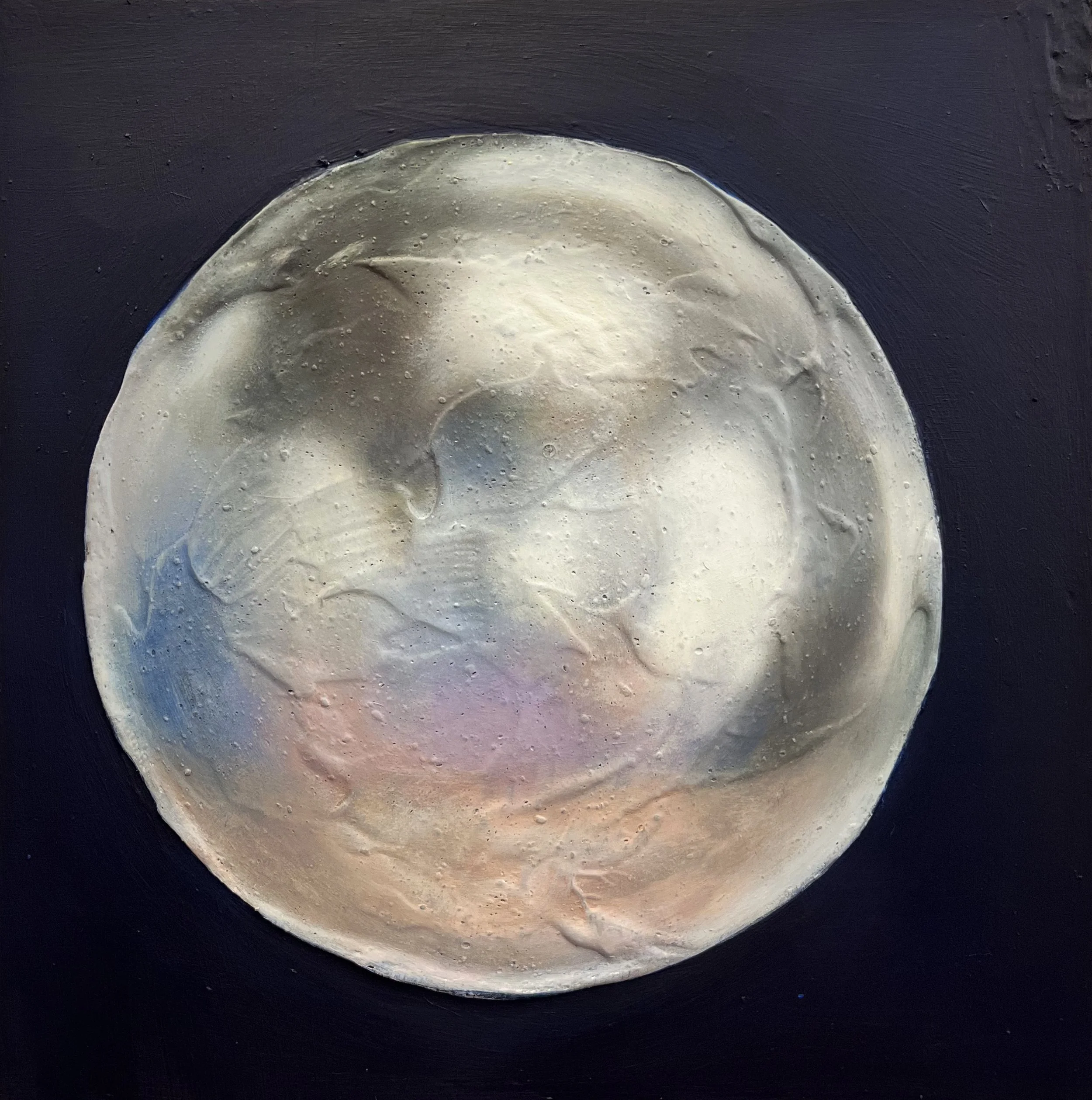Close-up of the moon's surface showing craters and uneven terrain against a black background.