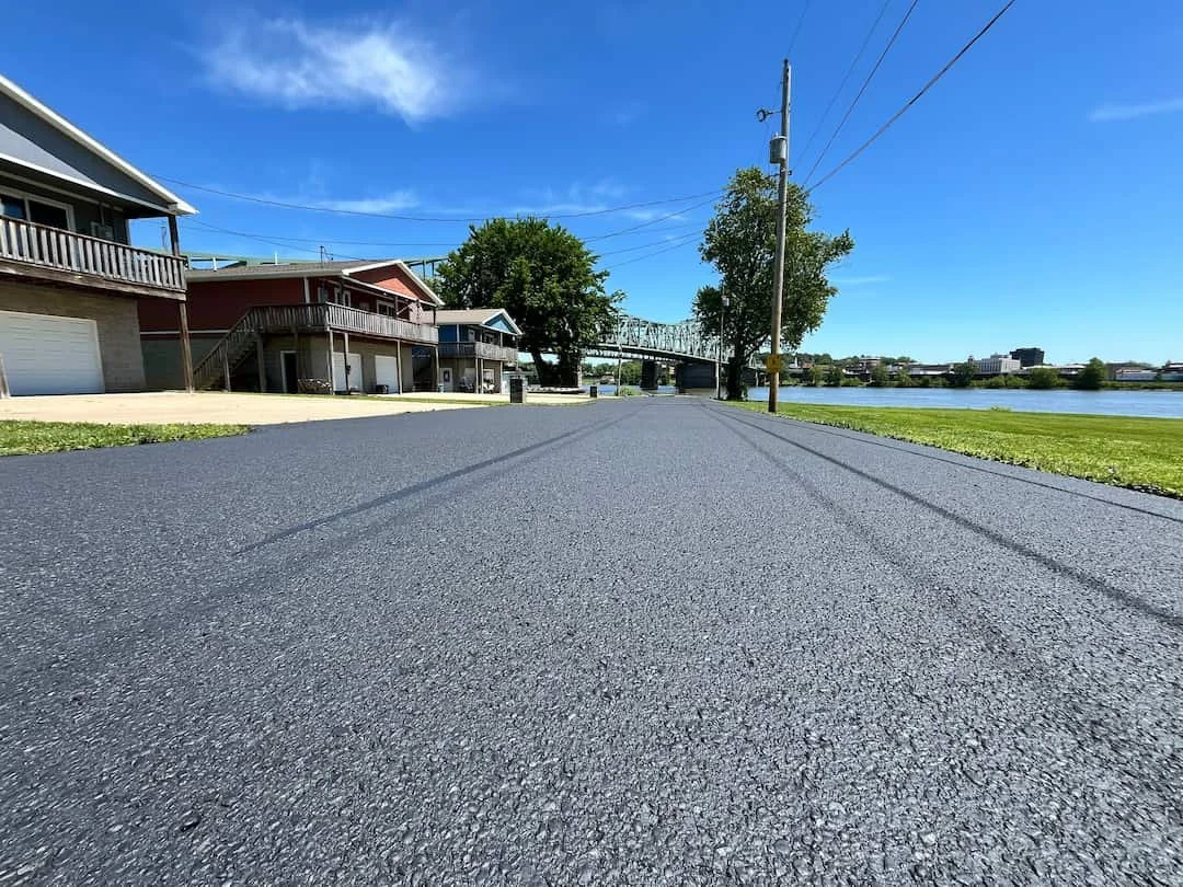 Residential driveway sealcoating in Williamstown WV with smooth black asphalt finish and long-lasting weather protection.