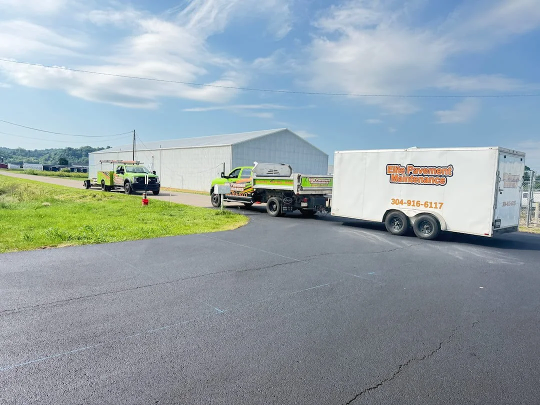 Elite Pavement Maintenance equipment on site during airport parking lot sealcoating and striping project in Gallipolis OH.