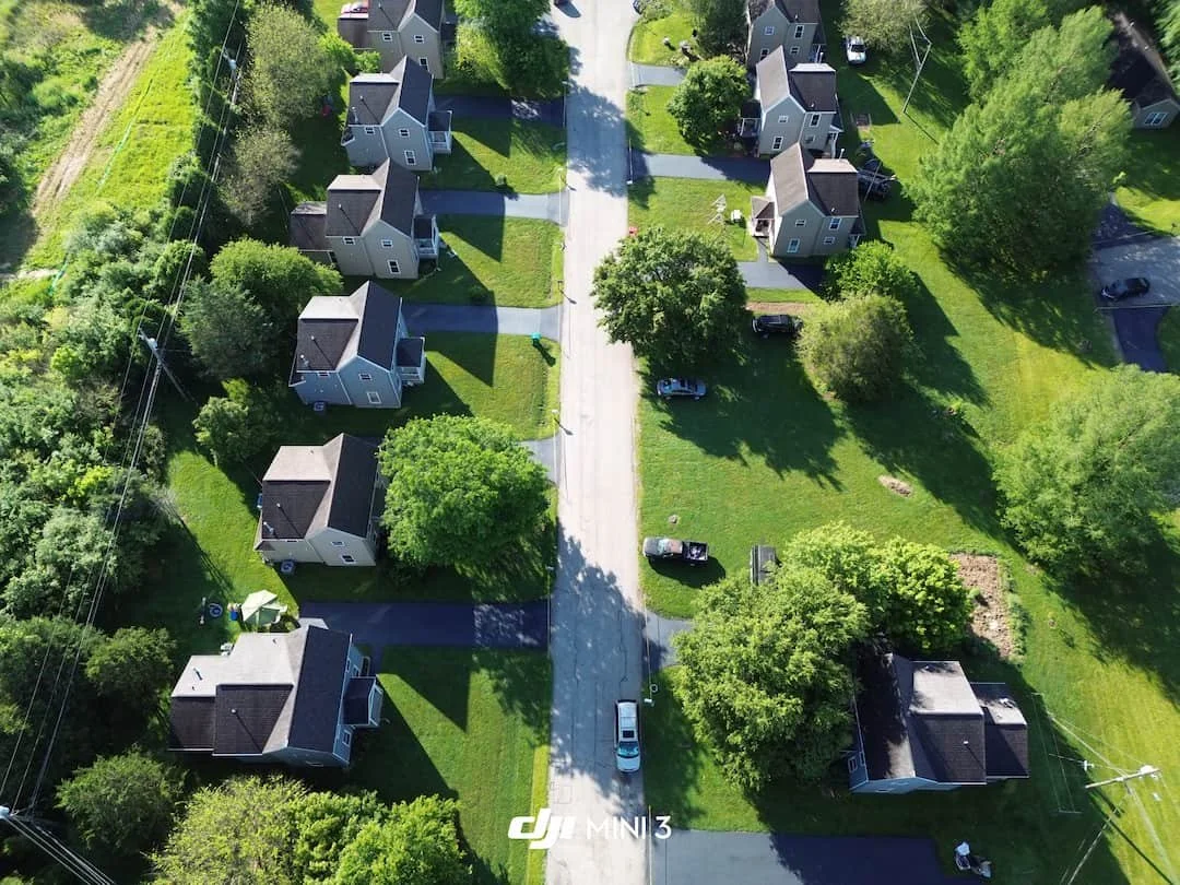 Residential driveway sealcoating project in Athens OH showing freshly sealed asphalt from above.