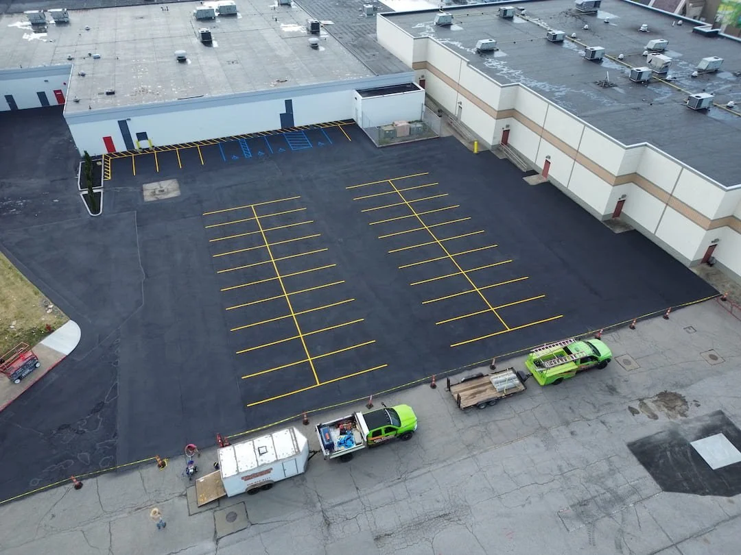 Second coat of asphalt sealcoating with a heavy sand mix applied at Grand Central Mall in Vienna WV for improved traction and durability.