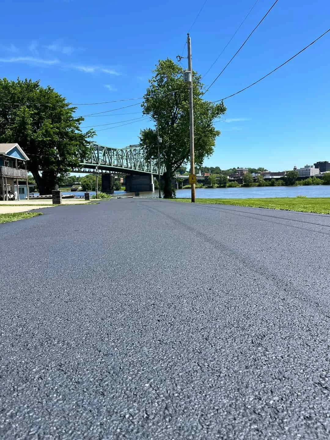 Residential driveway sealcoating in Mineral Wells WV protecting asphalt from weather, fading, and surface cracking.