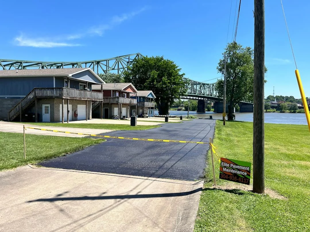 Residential driveway sealcoating in Parkersburg WV with fresh black asphalt finish protecting against weather, fading, and cracking.