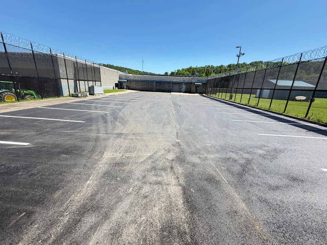 Commercial parking lot striping project at North Central Regional Jail in Clarksburg WV with fresh white parking lines and improved parking organization.