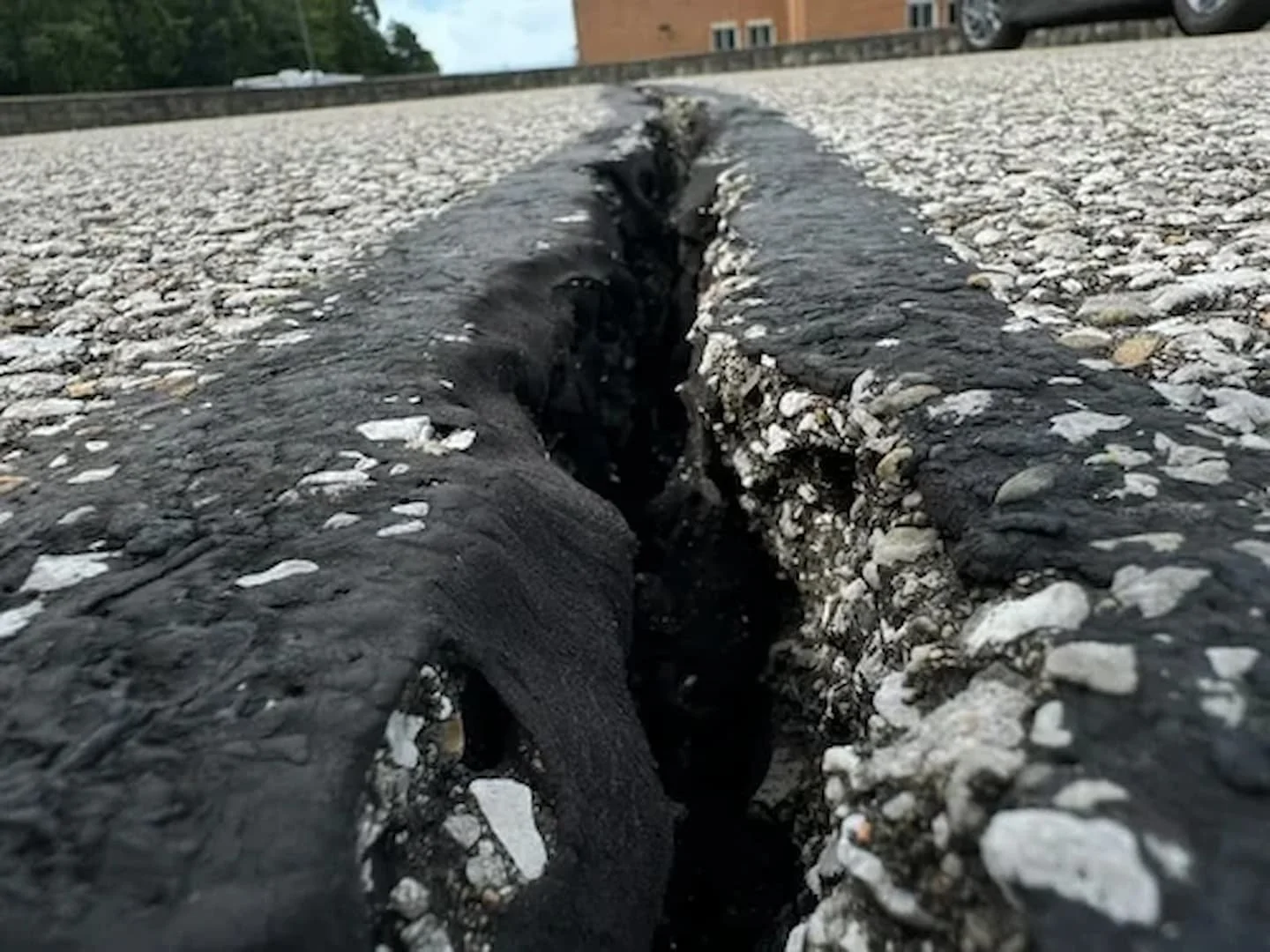 Asphalt crack filling services in Parkersburg WV by Elite Pavement Maintenance to prevent water damage and pavement deterioration.