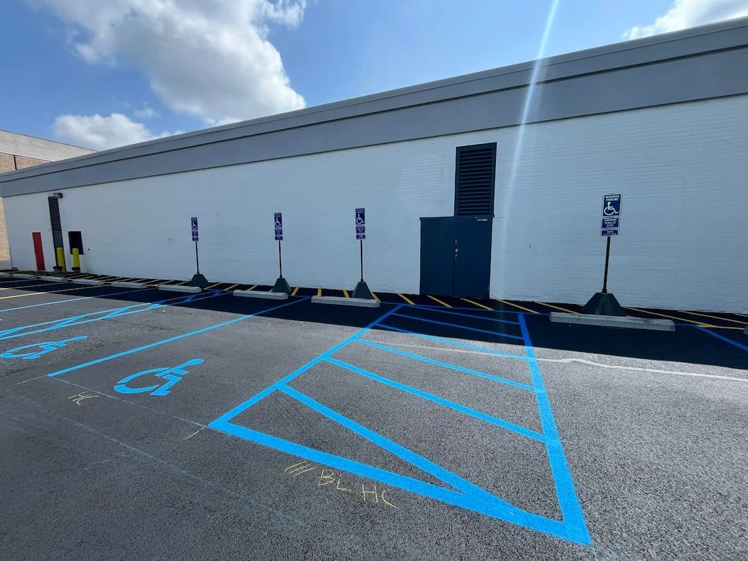 New ADA handicap parking signs installed at Grand Central Mall in Vienna WV to improve accessibility and maintain ADA compliance.