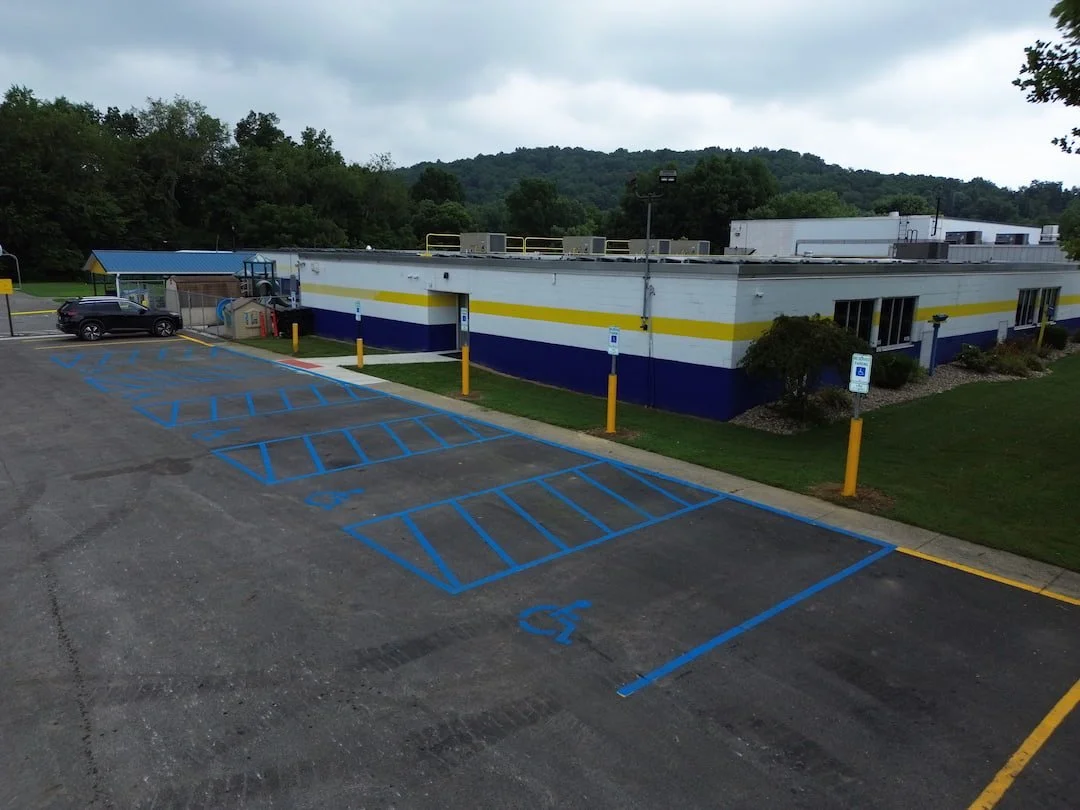 Thermoplastic pavement markings installed at Kanawha Elementary School in Davisville WV for long-lasting crosswalks and traffic control markings.