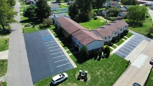 Parking lot sealcoating in Marietta OH with fresh black asphalt finish protecting pavement from weather and traffic damage.