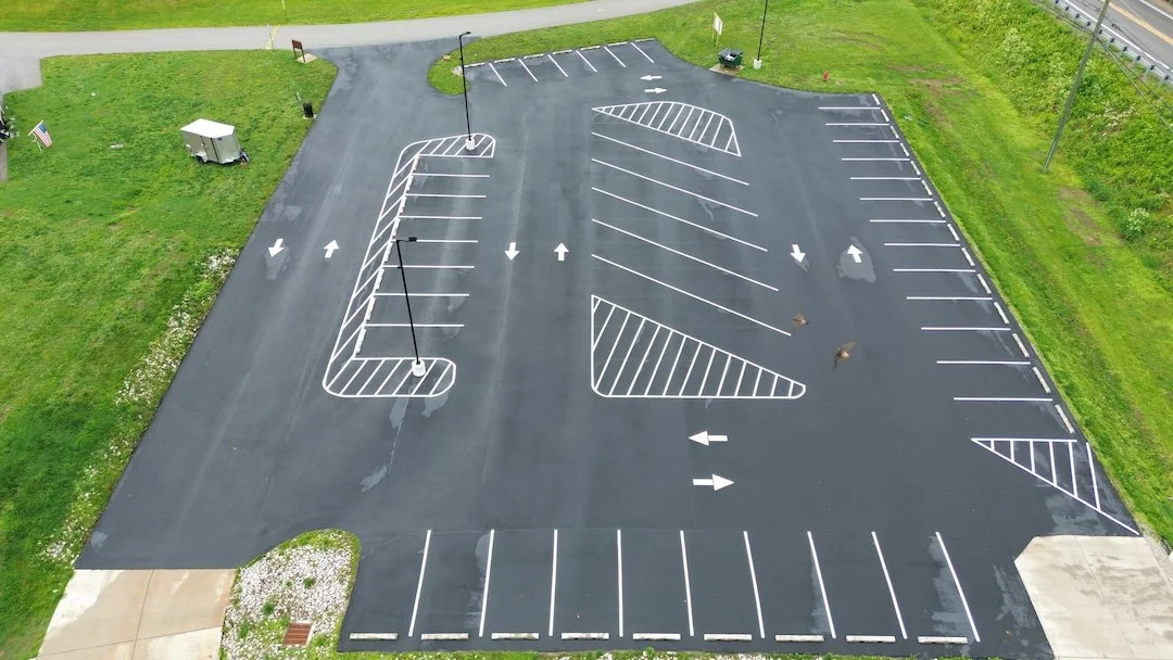 Finished marina parking lot sealcoating and striping project in Ravenswood WV with fresh asphalt and clean markings.