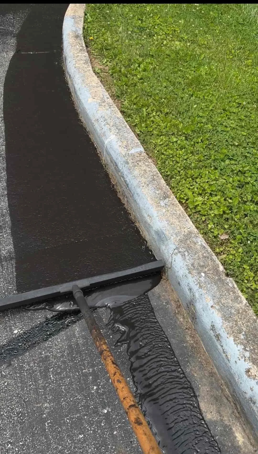 Commercial parking lot sealcoating project in Athens OH with newly sealed asphalt and improved curb appeal.