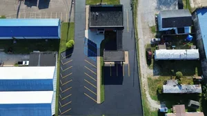 Parking lot sealcoating in Parkersburg WV with fresh black asphalt finish protecting pavement from weather and traffic damage.