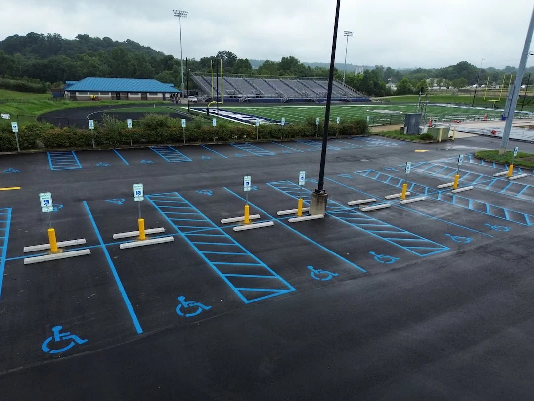 Commercial parking lot crack filling, asphalt sealcoating, and fresh line striping completed in Parkersburg WV to protect pavement and extend the life of the asphalt.