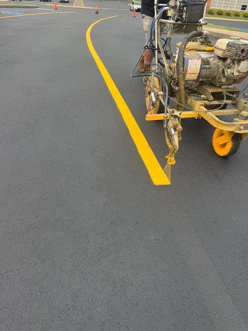 Parking lot striping with clean yellow lines improving safety, traffic flow, ADA compliance, and parking organization for commercial properties.