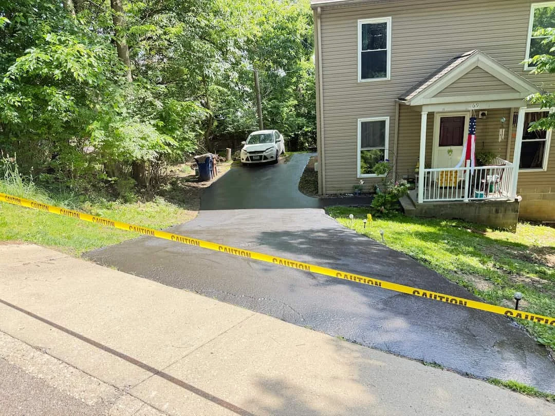 Residential driveway sealcoating project in Athens OH helping protect asphalt from weather and cracking.