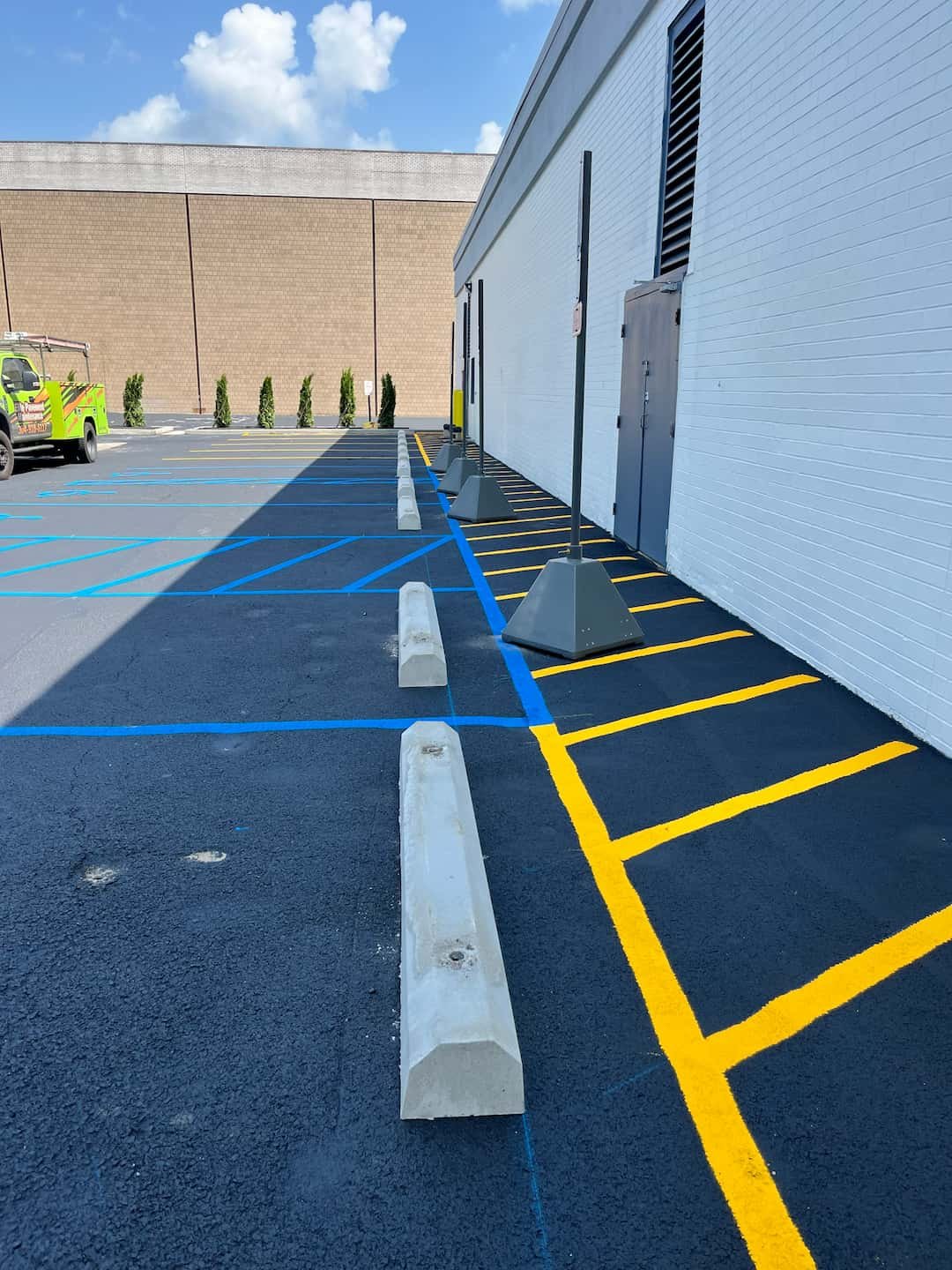 First coat of commercial parking lot sealcoating being applied at Grand Central Mall in Vienna WV by Elite Pavement Maintenance.