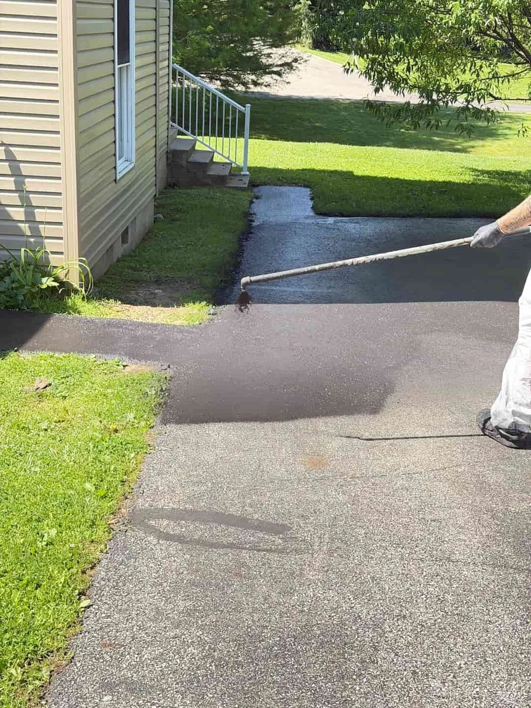 Applying commercial-grade sealcoating to a residential driveway in Athens OH for long-term asphalt protection.