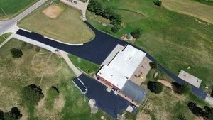 Parking lot sealcoating in Vienna WV with fresh black asphalt finish protecting pavement from weather and traffic damage.