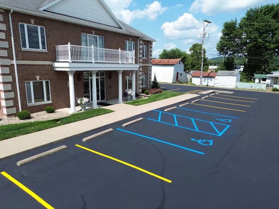Commercial parking lot striping and ADA handicap sign installation completed by Elite Pavement Maintenance in Parkersburg WV to improve safety, accessibility, and traffic flow.