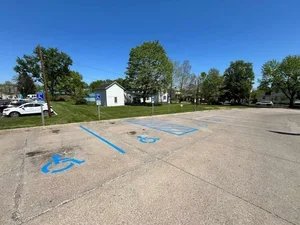 Parking lot striping and ADA handicap parking spaces in Parkersburg WV with fresh blue markings and clean asphalt.