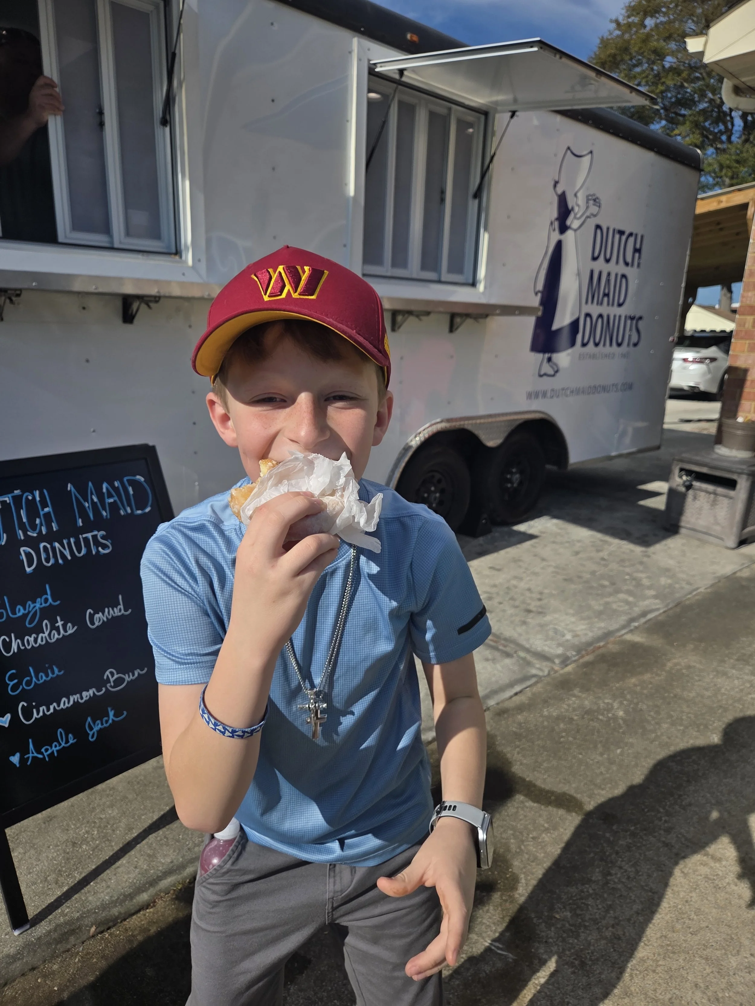 Boy Eating Dutch Maid Donuts