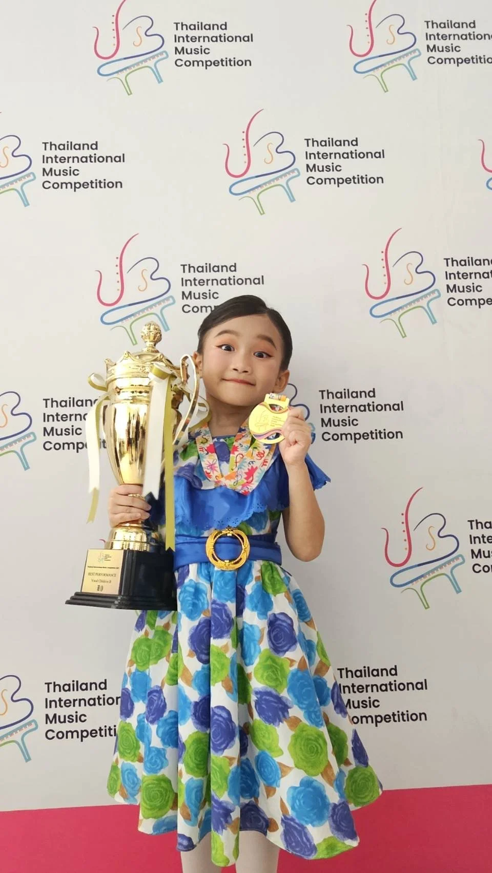 Student holding Thailand International Music Competition trophy - Private Singing & Acting Lessons Bangkok
