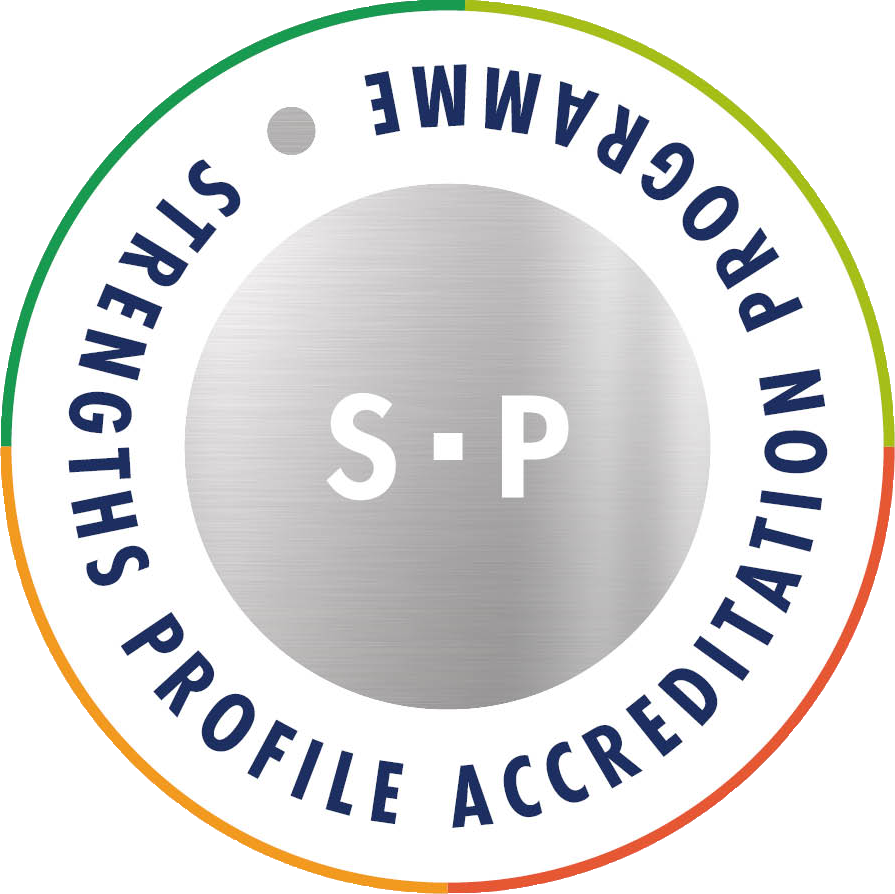 A circular badge with a silver center containing the letters S and P. Surrounding the center is a white ring with dark blue text that reads "SHIELD PROFILE ACCREDITATION" and "SHIELD PROFILE" with a small gray dot between the words. The outer edge has a gradient color from green to orange.