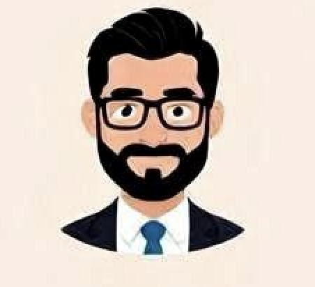 A man with curly dark hair, glasses, and a beard, wearing a dark sweater, looking off to the side with a neutral expression in a bright indoor setting.