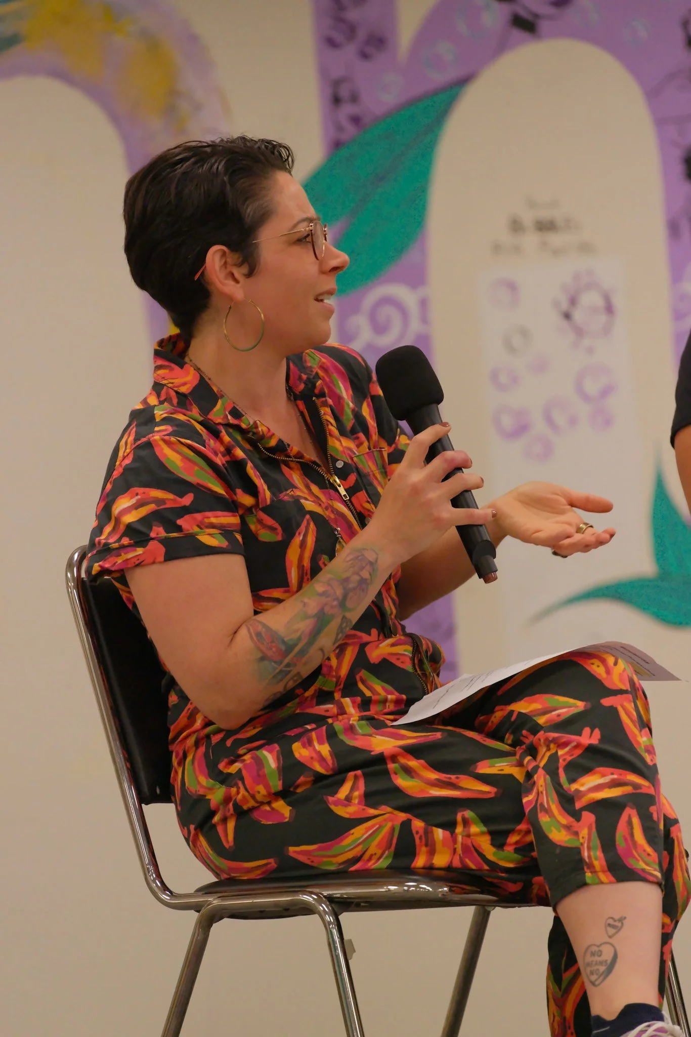 Facilitating an Artist's Talk at The VAPA Center with the COMMUNITY Mural in the background 2023