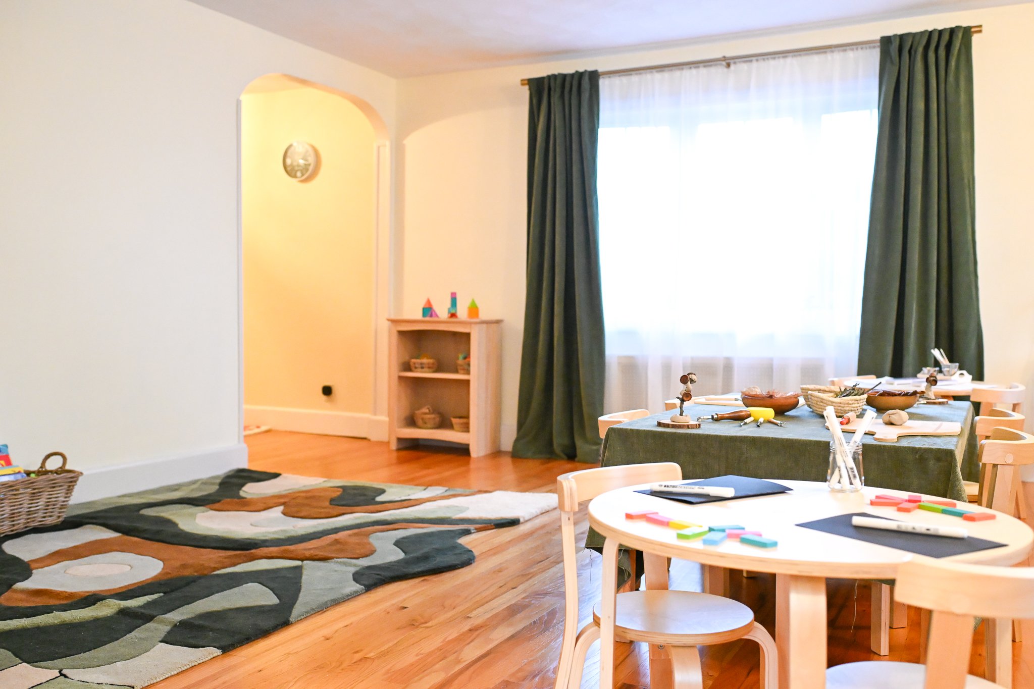 Classroom interior with student tables and chairs, ready for a lesson.