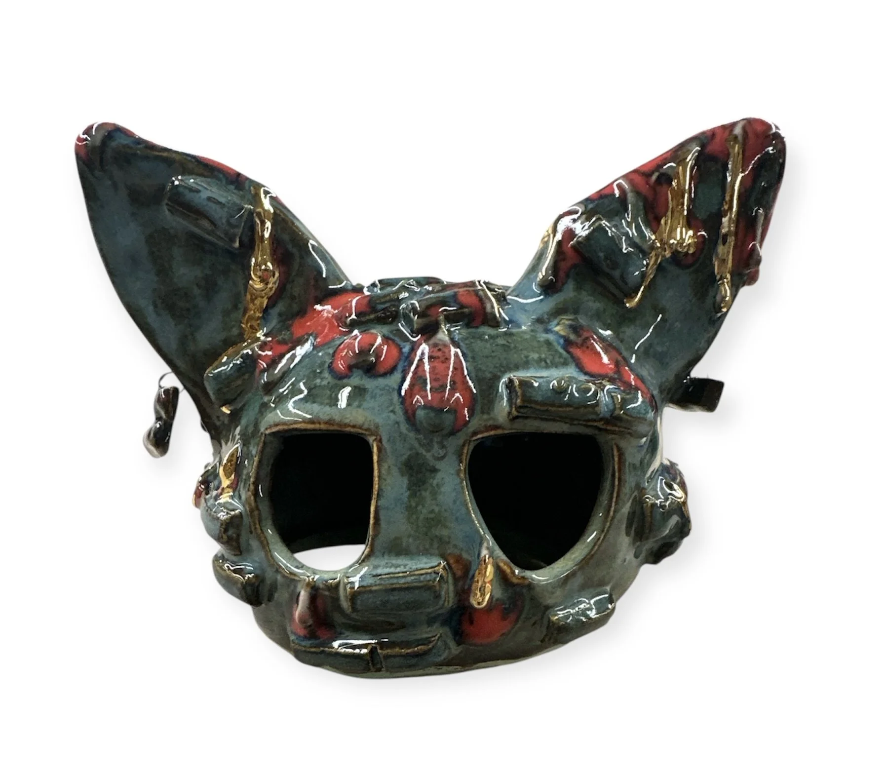 A slip-casted cat figurehead with droops of glace and lustre outlines.