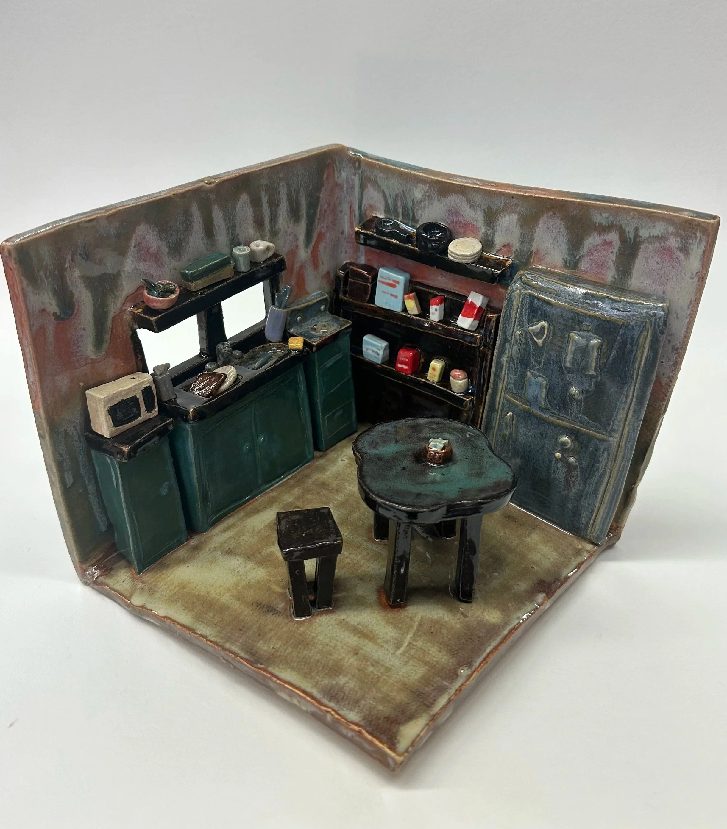 A cool-toned kitchen with small furniture pieces and decor.