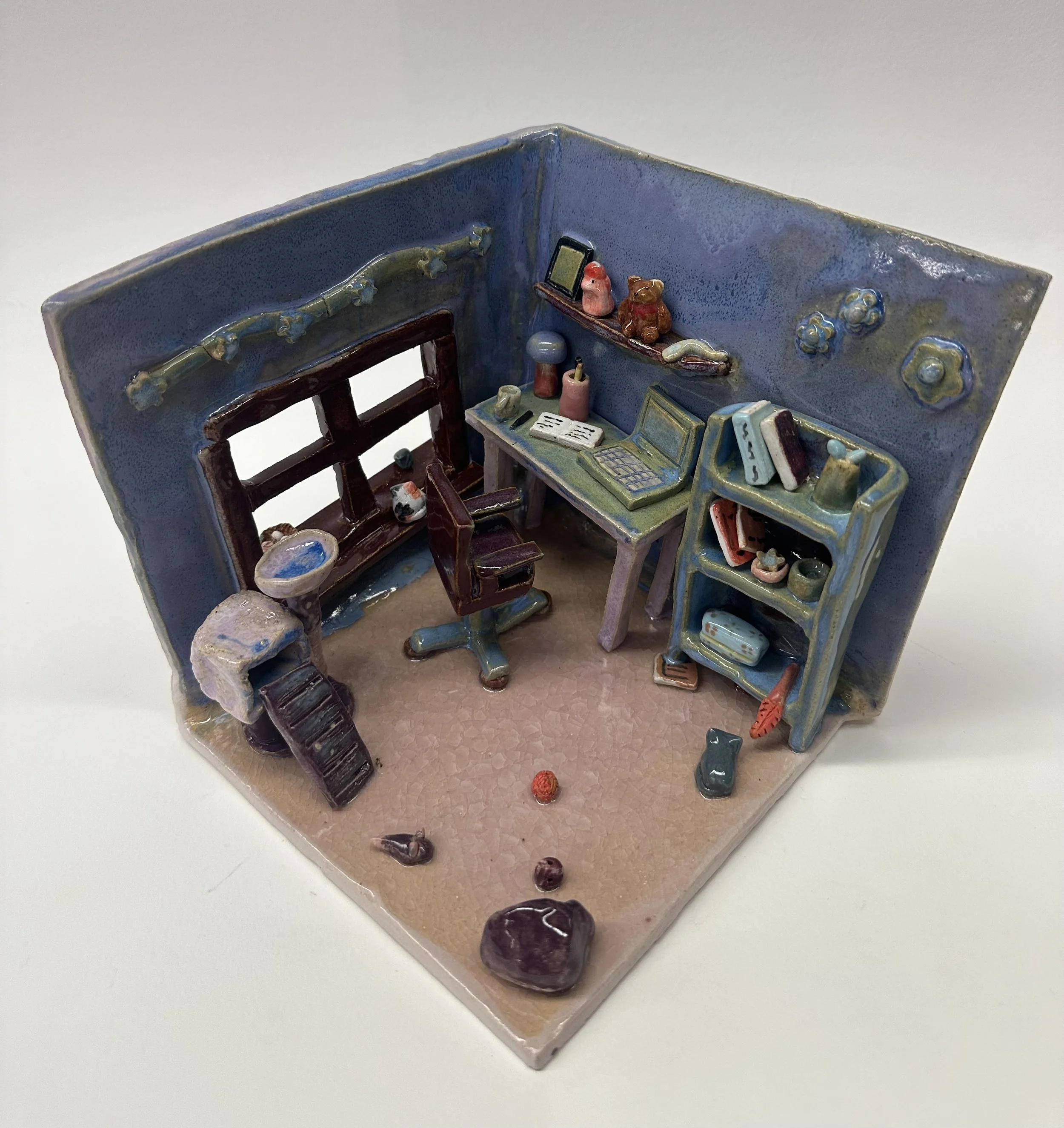 A pastel-colored home office with small pieces of furniture.