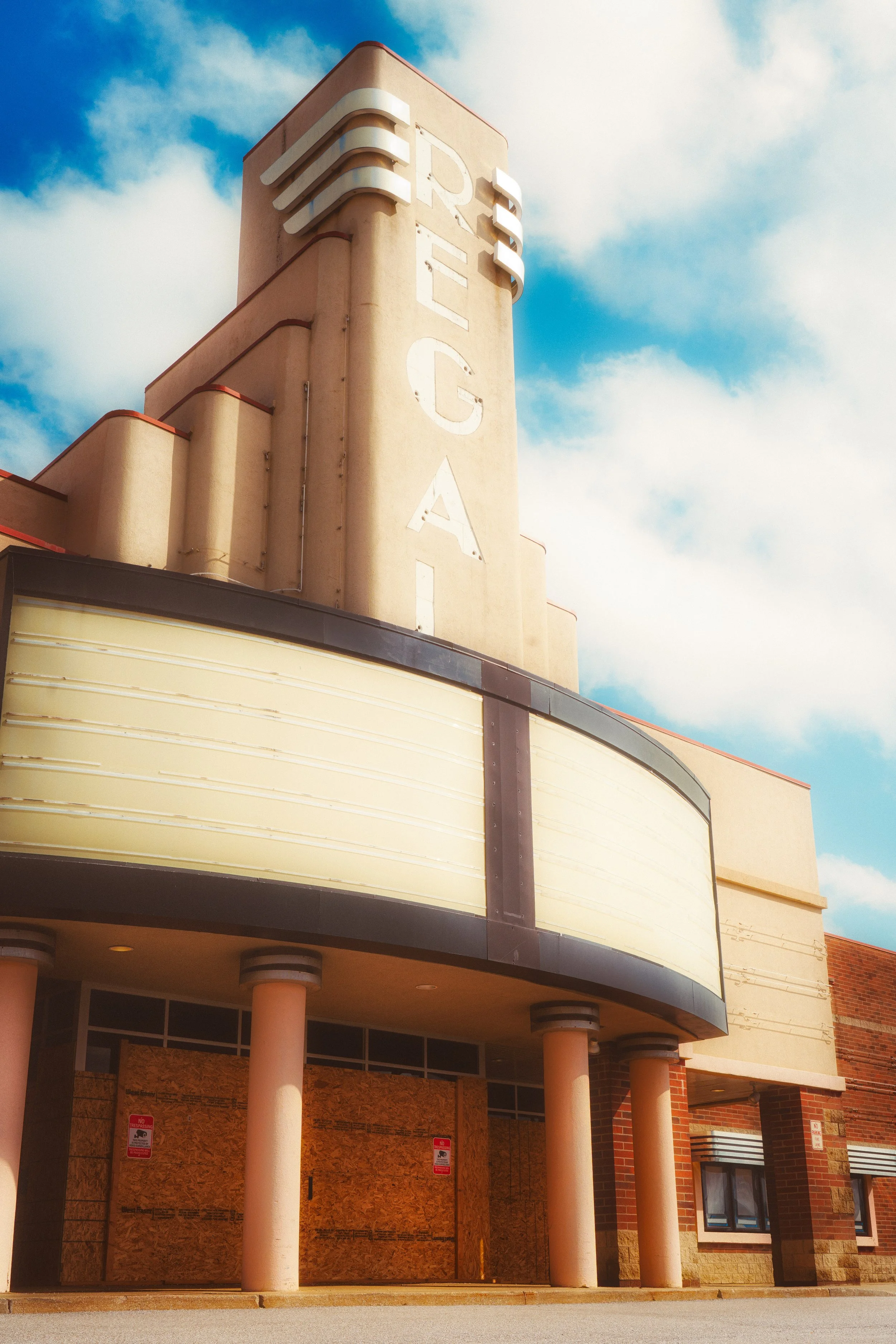 Warm light falls across a classic theater facade, preserving the character and architectural detail of a historic city landmark.