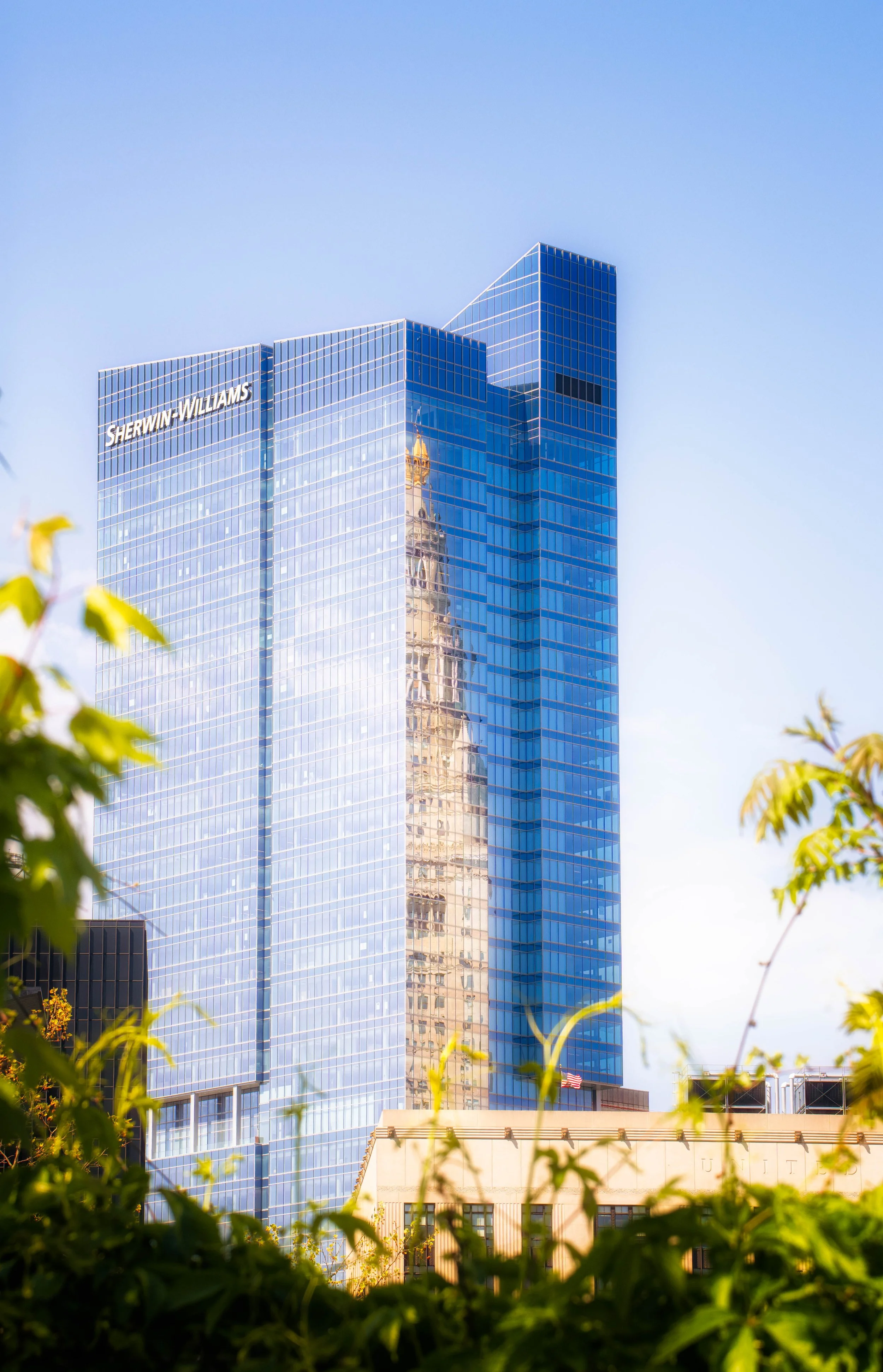 Glass and steel surfaces reflect light and surrounding structures, capturing the evolving modern skyline.