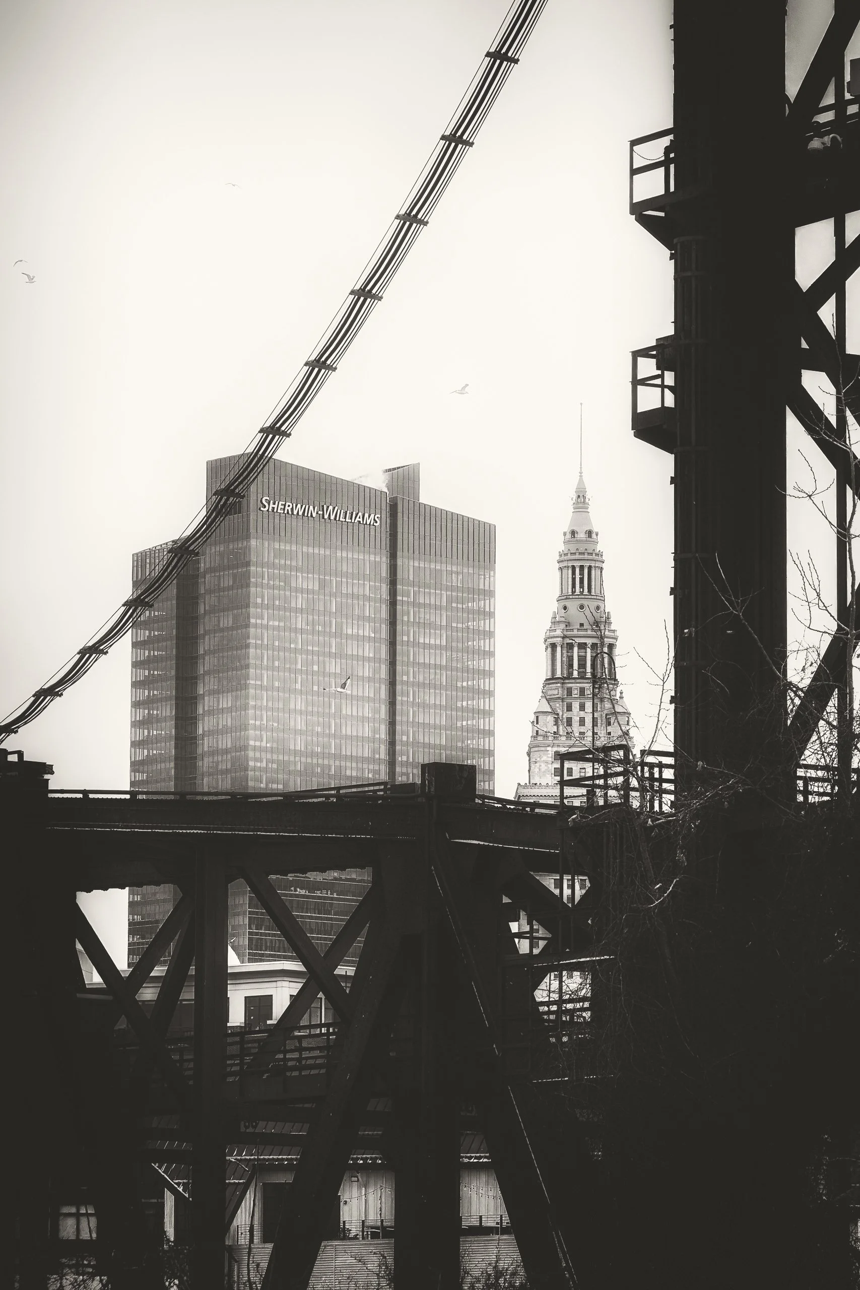 Steel structures and urban elements intersect, highlighting the layered geometry of the city’s industrial landscape.