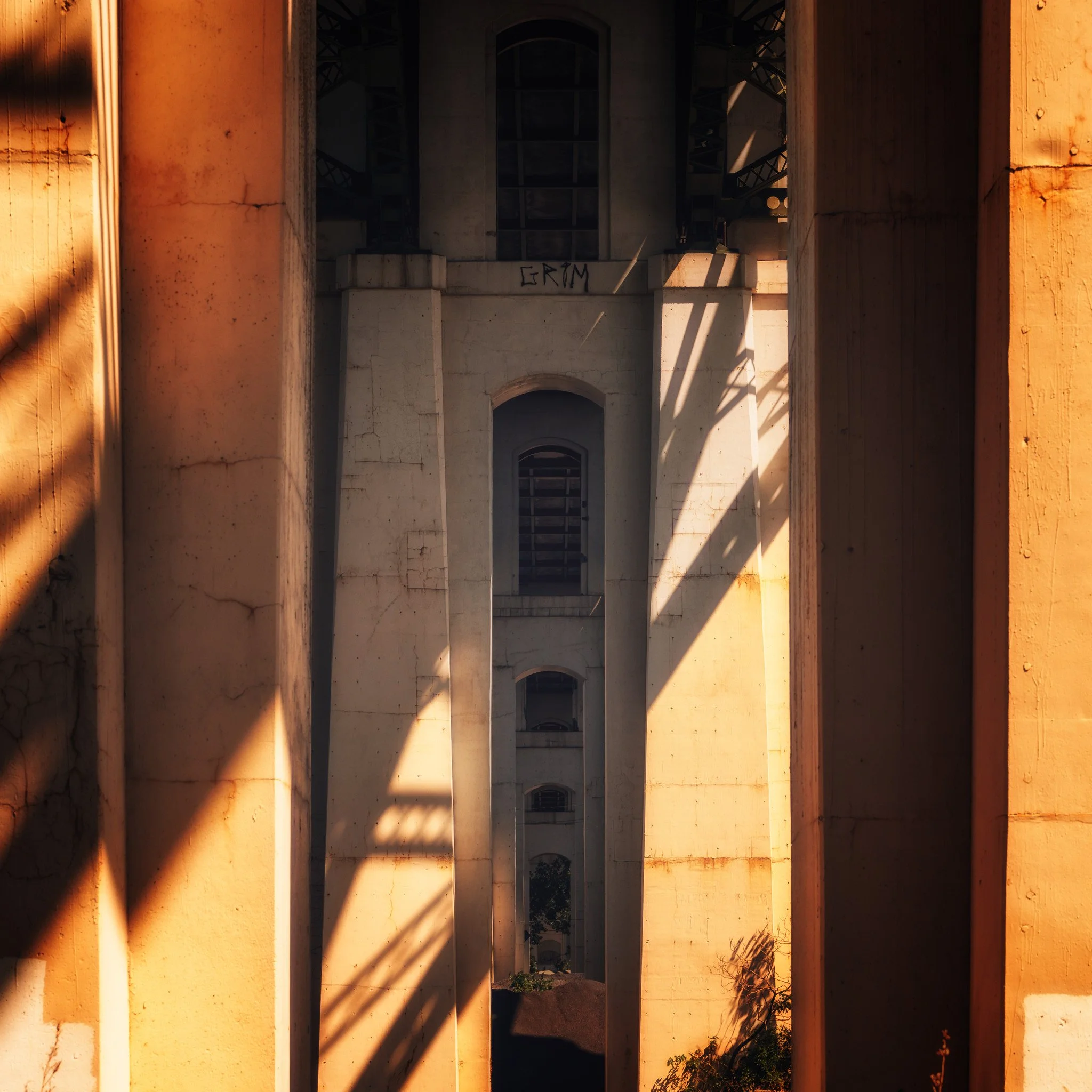 Sunlight moves through narrow city spaces, revealing texture and depth within downtown architectural forms.