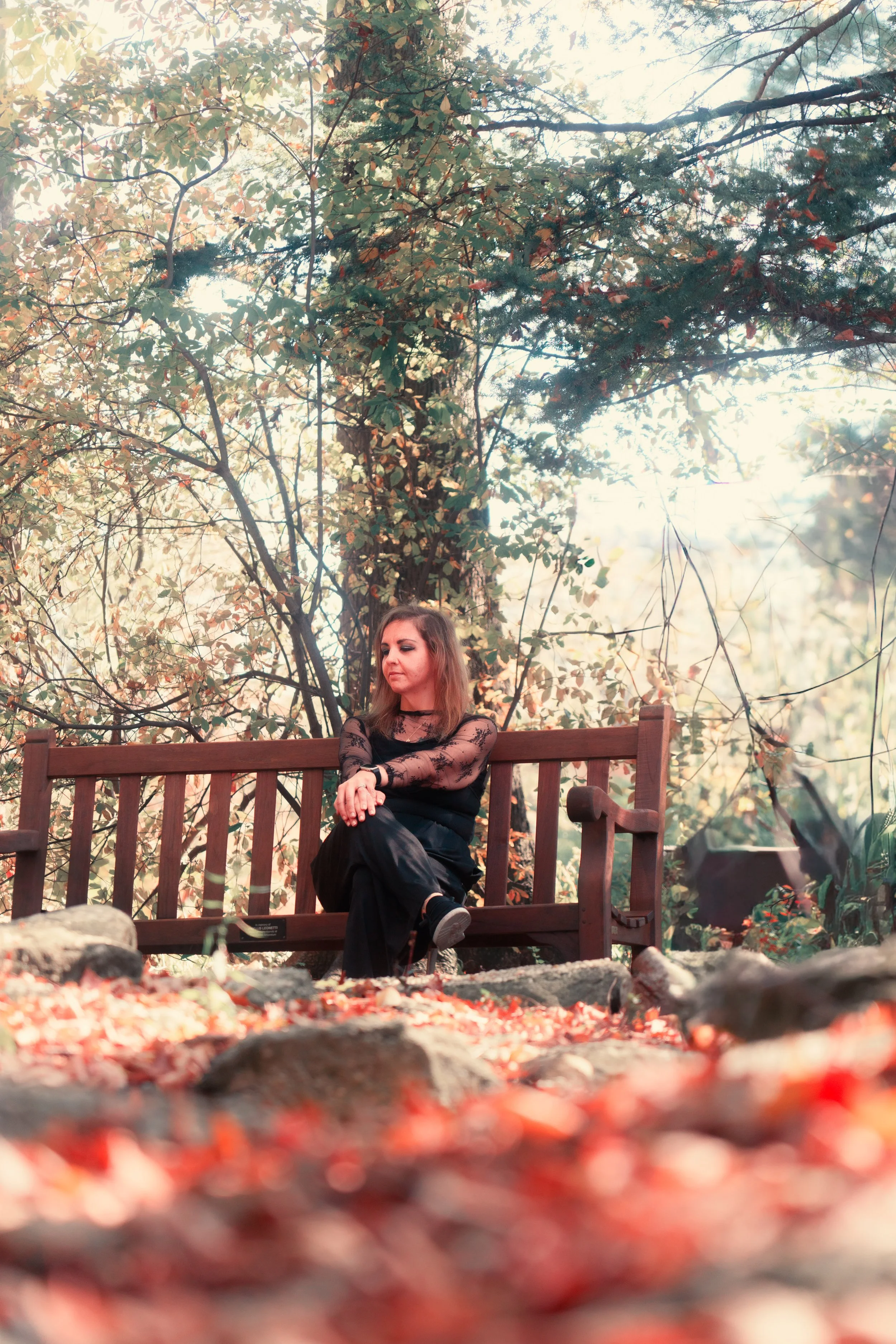 Seasonal color surrounds the subject, creating a warm and natural portrait within an autumn landscape.