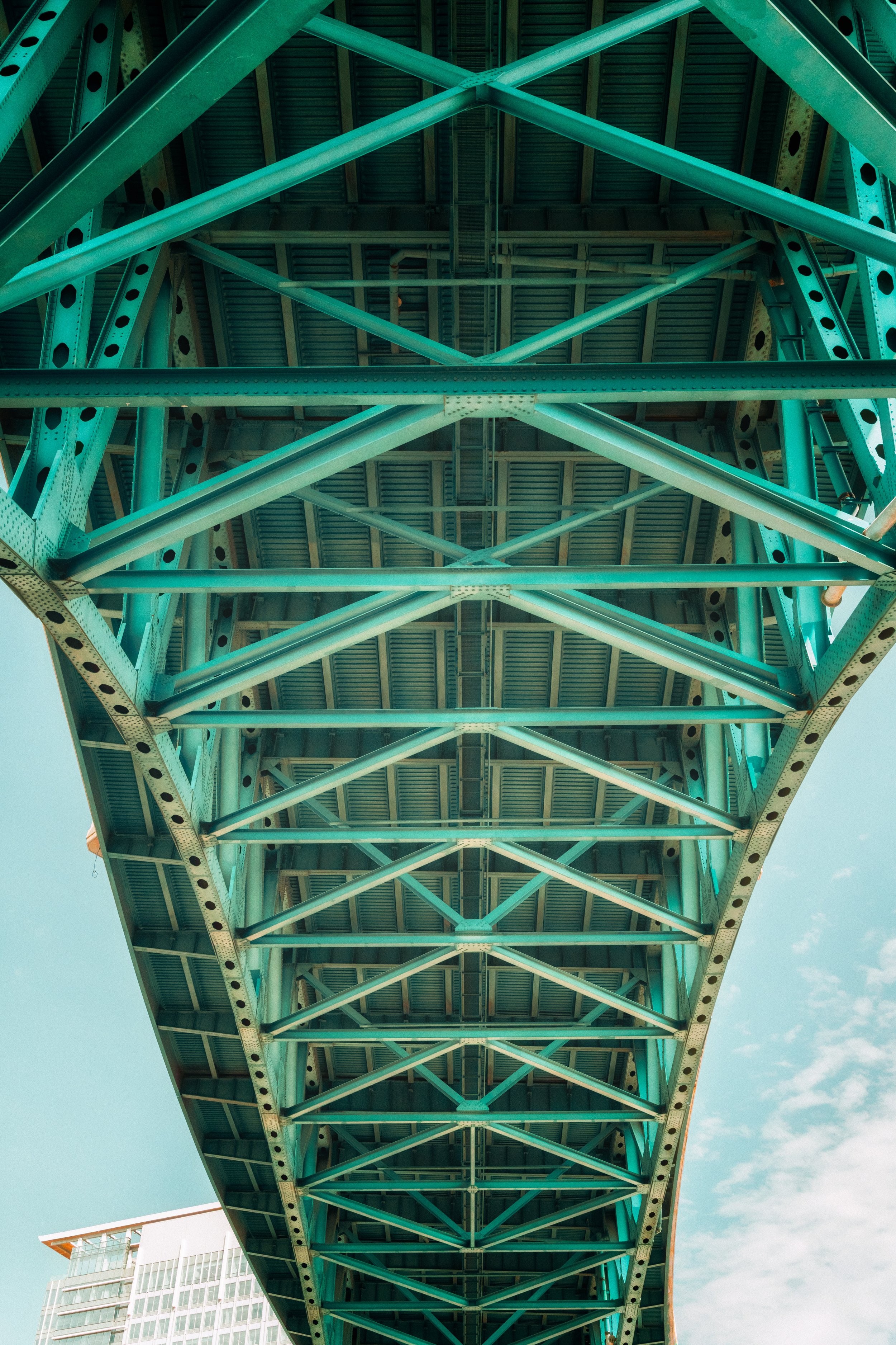 Structural lines converge beneath a steel bridge, emphasizing symmetry and industrial design within Cleveland’s urban landscape.