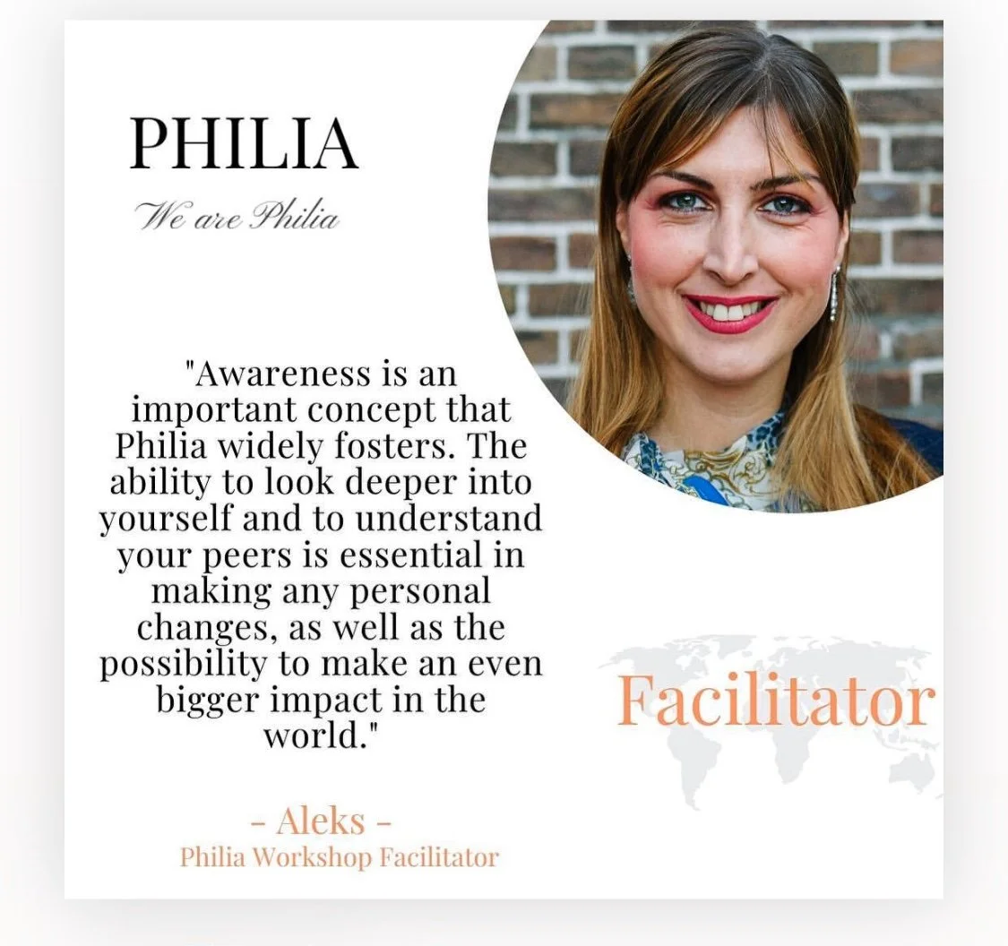 A promotional graphic featuring a headshot of a woman with light brown hair, smiling with red lipstick, wearing earrings, and a floral scarf. The background shows a brick wall. The graphic includes the text 'PHILIA We are Philia', a quote about aware