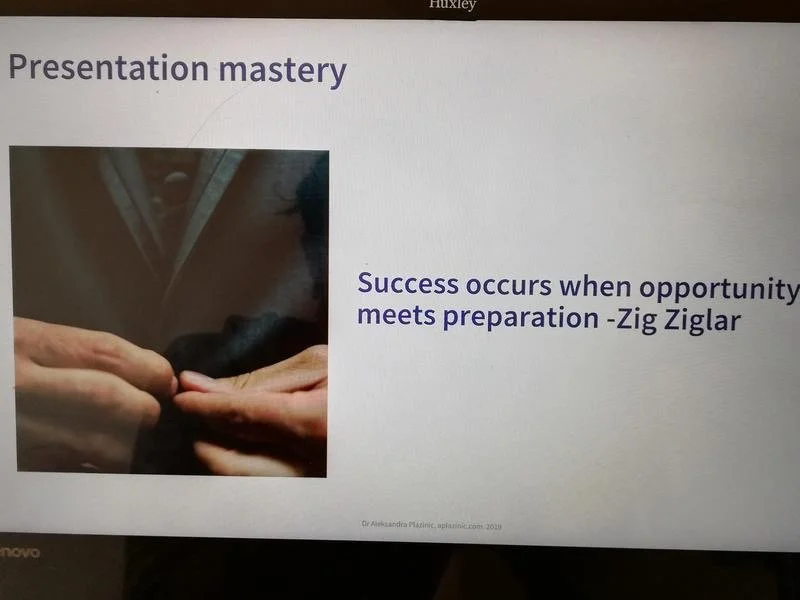 Presentation slide with the title 'Presentation mastery'. It includes a photo of two people exchanging a small object. The slide quotes Zig Ziglar: 'Success occurs when opportunity meets preparation.'