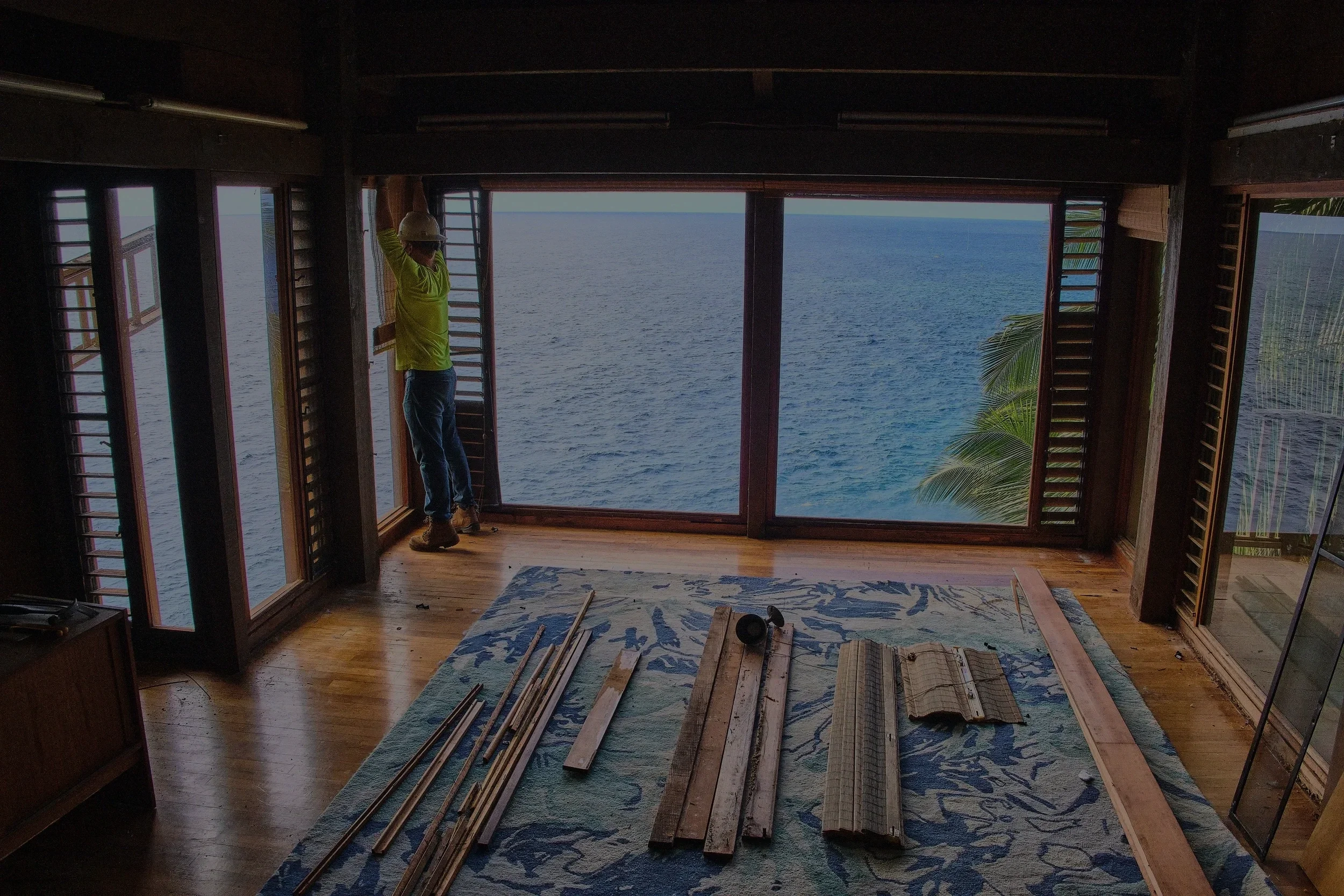 Close-up image of a home being deconstructed by hand.